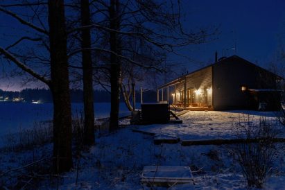Ilta hämärtyy Aulangon Rantahuvilalla. Etualalla puulämmitteinen kylpypalju.