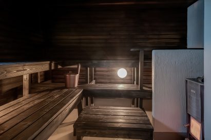 Yksi Räyskälän Suuren Huvilan alakerran kolmesta saunasta on perinteinen puulämmitteinen sauna.
